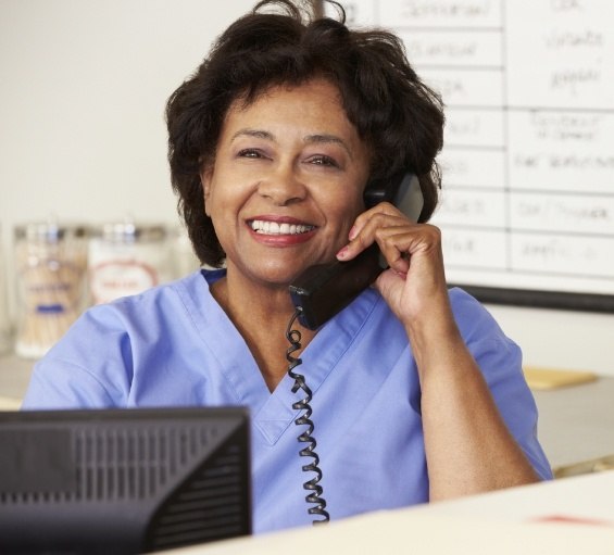 Smiling Windham dental team member talking on the phone