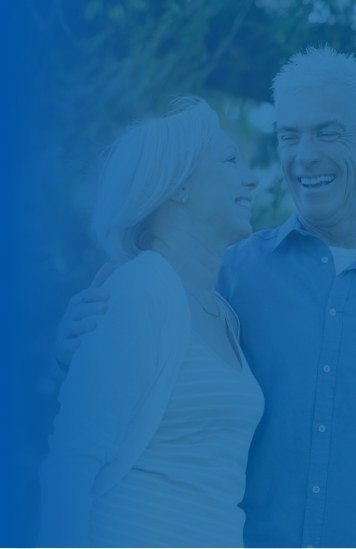 Older man and woman laughing together outdoors