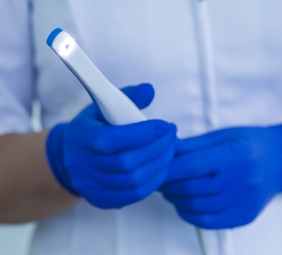 Dental professional holding an intraoral camera