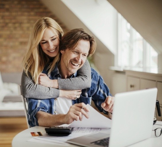 Man and woman looking at laptop together